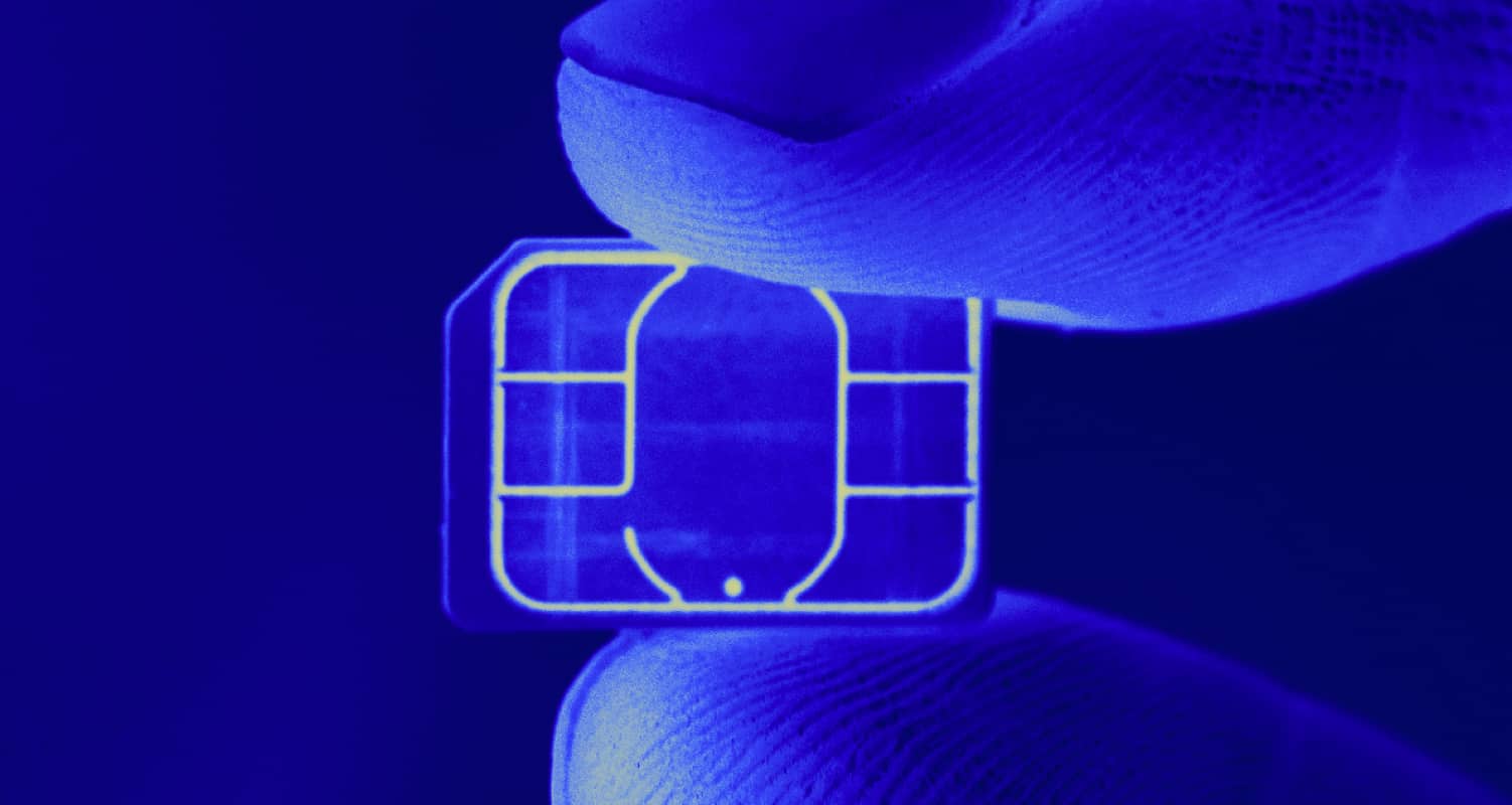 SIM swap fraud small chip between two fingers - header