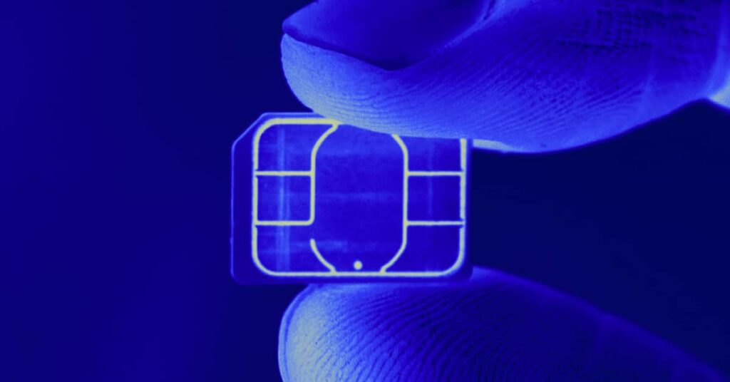 SIM swap fraud small chip between two fingers - featured