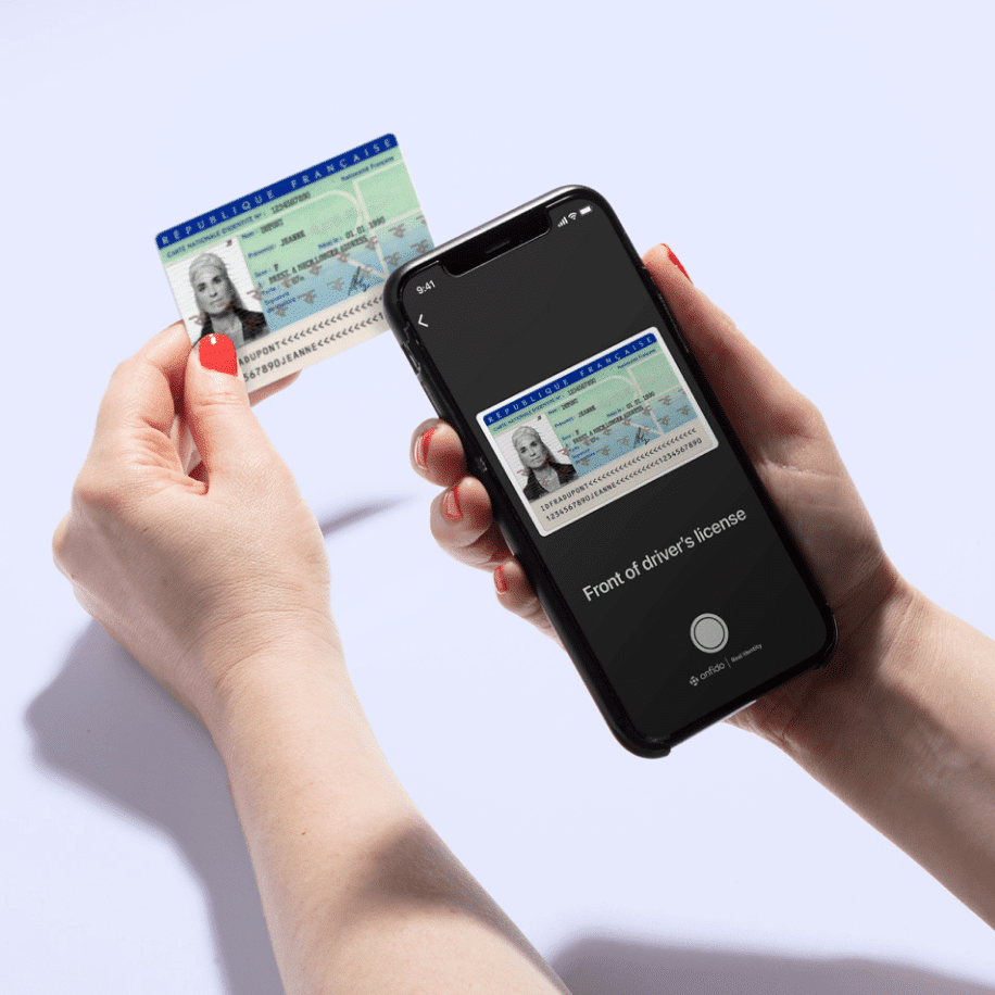 User holding phone scanning drivers license
